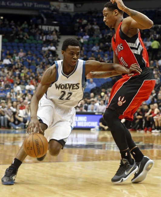 Minnesota Timberwolves’ Andrew Wiggins, left, gives a shove to Toronto Raptors’ DeMar DeRozan as he drives in the first quarter of an NBA basketball game, Wednesday, April 1, 2015, in Minneapolis. 