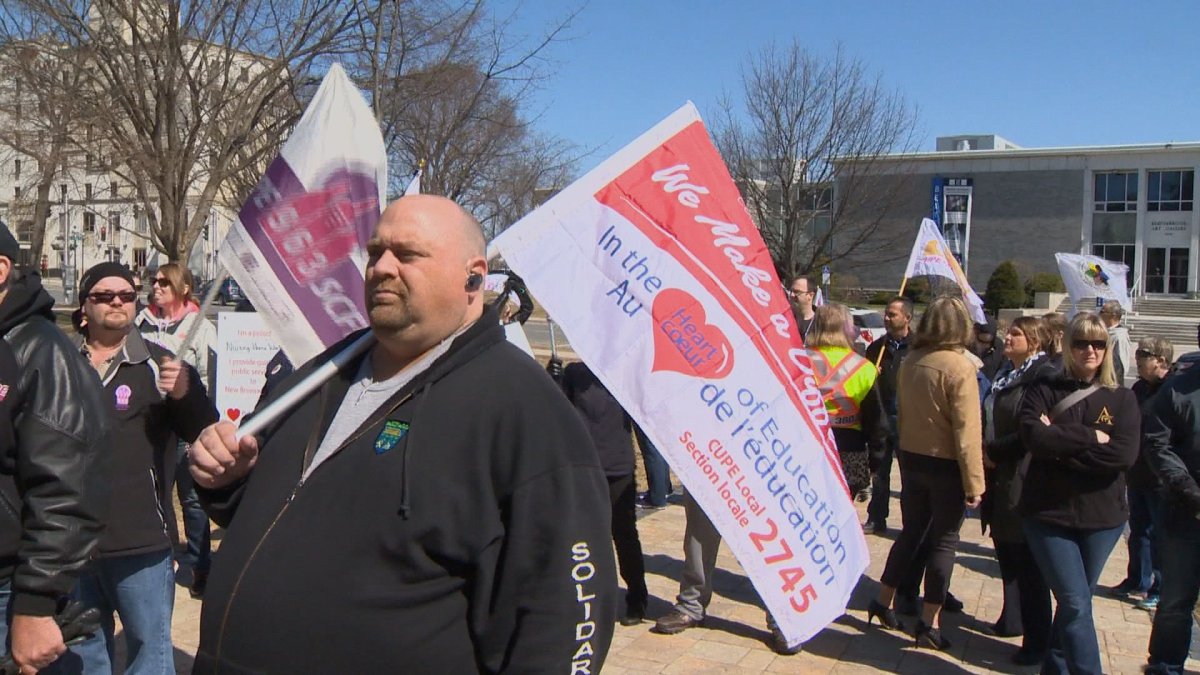 Protesters rally outside New Brunswick legislature in Fredericton on Thursday, April 16.