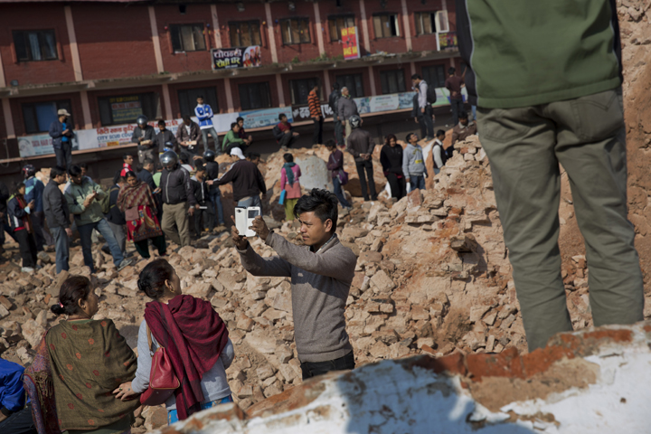 A man takes a selfie at the historic Dharahara Tower, a city landmark, that was damaged in Saturday’s earthquake in Kathmandu, Nepal, Monday, April 27, 2015.