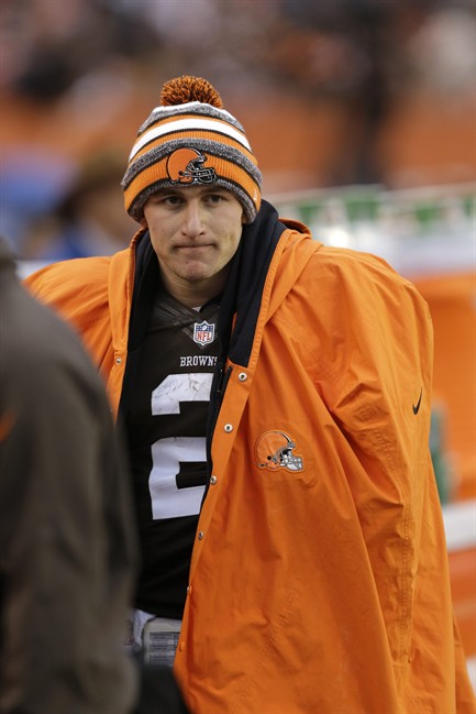 In this Dec. 14, 2014 file photo, Cleveland Browns quarterback Johnny Manziel watches from the sidelines.
