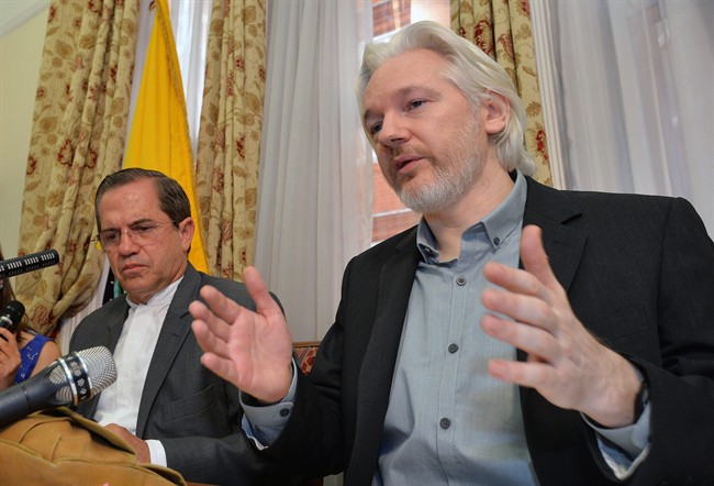 FILE - In this Aug. 18, 2014, file photo, Ecuador's Foreign Minister Ricardo Patino, left, and WikiLeaks founder Julian Assange speak during a news conference inside the Ecuadorian Embassy in London.