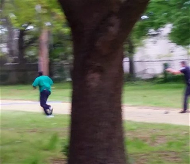 In this April 4, 2015, frame from video provided by Attorney L. Chris Stewart representing the family of Walter Lamer Scott, Scott appears to be running away from City Patrolman Michael Thomas Slager, right, in North Charleston, S.C.