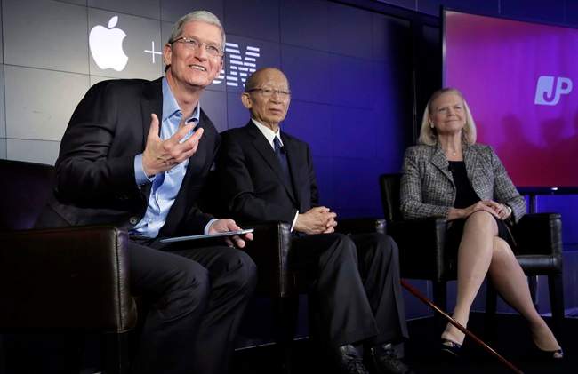 Apple CEO Tim Cook, left, addresses a news conference, joined by Japan Post CEO Taizo Nishimuro, and IBM CEO Ginni Rometty, at IBM Watson headquarters, in New York, Thursday, April 30, 2015. Apple, IBM and Japanese insurance and bank holding company Japan Post have formed a partnership to improve the lives of elderly people in the country. The program will provide iPads with apps designed to help seniors manage day-to-day lives and keep in touch with family members.