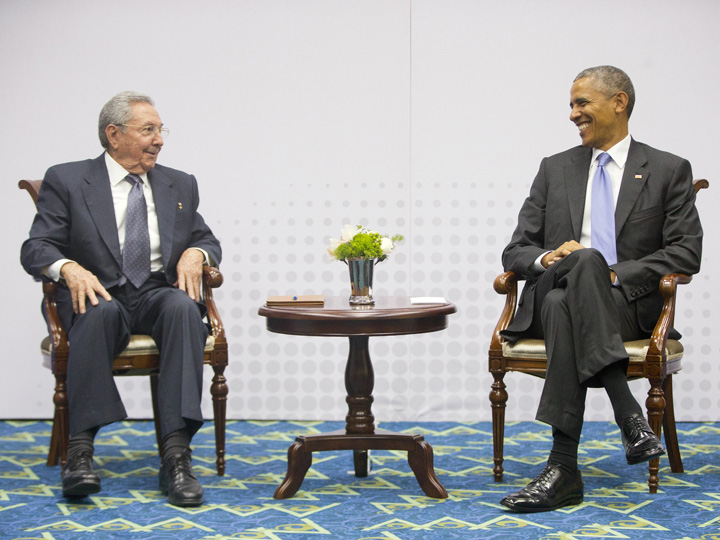 US President Barack Obama, right, smiles as he looks over towards Cuban President Raul Castro, left, during their meeting at the Summit of the Americas in Panama City, Panama, Saturday, April 11, 2015. 
