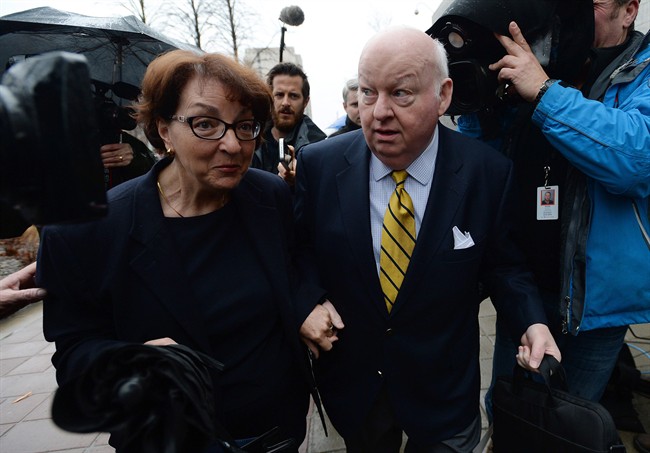 Suspended senator Mike Duffy, right, arrives with wife Heather Duffy to the courthouse in Ottawa on Friday, April 10, 2015. Duffy is facing 31 charges of fraud, breach of trust, bribery, frauds on the government related to inappropriate Senate expenses. THE CANADIAN PRESS/Sean Kilpatrick.