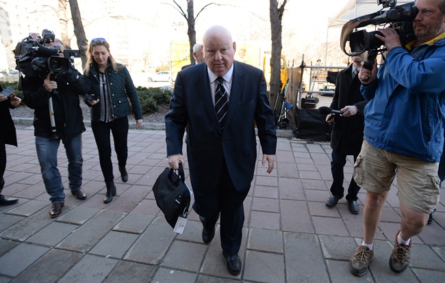 Suspended senator Mike Duffy arrives to the courthouse in Ottawa on Tuesday, April 14, 2015. Duffy is facing 31 charges of fraud, breach of trust, bribery, frauds on the government related to inappropriate Senate expenses. THE CANADIAN PRESS/Sean Kilpatrick.