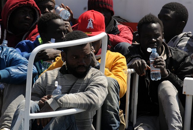 Migrants arrive at Palermo's harbor, Italy, after being rescued at sea, Wednesday, April 15, 2015.