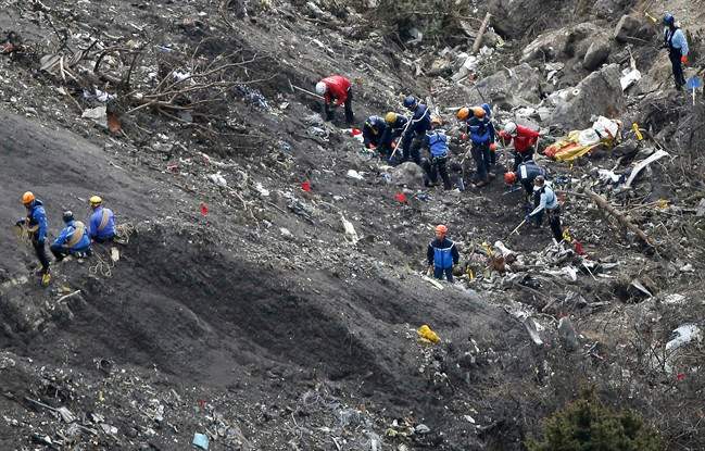 In this Thursday, March 26, 2015 file photo, rescue workers work at debris of the Germanwings jet at the crash site near Seyne-les-Alpes, France. 
