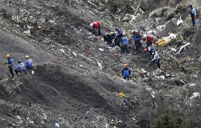 In this Thursday, March 26, 2015 file photo, rescue workers work at debris of the Germanwings jet at the crash site near Seyne-les-Alpes, France. 