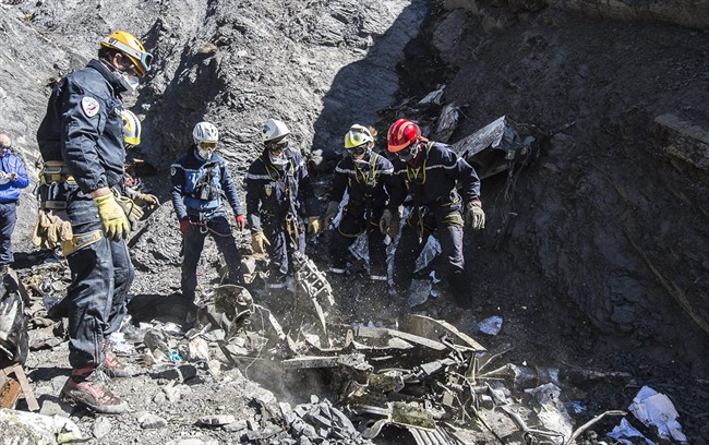 In this photo taken on Tuesday, March 31, 2015 and provided by the French Interior Ministry, French emergency rescue services work among debris of the Germanwings passenger jet at the crash site near Seyne-les-Alpes, France. The heads of Lufthansa and its low-cost airline Germanwings are visiting the site of the crash that killed 150 people amid mounting questions about the co-pilot and how much his employers knew about his mental health.
