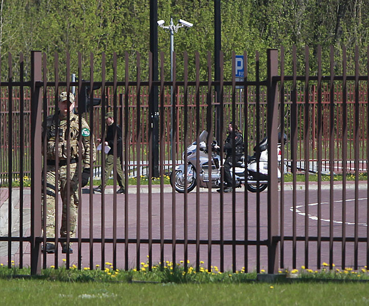 A Russian biker is led by a Polish customs officer for detailed customs control in Terespol, Poland, on Monday, April 27, 2015. 