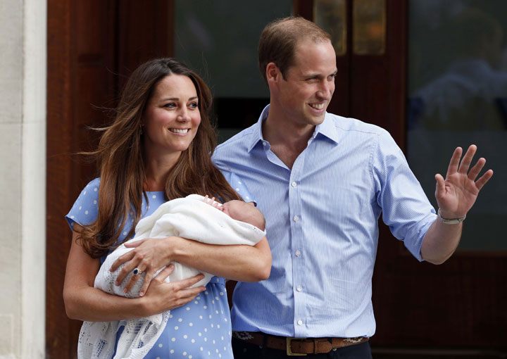 In this Tuesday, July 23, 2013 file photo, Prince William and Kate, Duchess of Cambridge hold their new born son George, as they pose for photographers outside St. Mary's Hospital in London. 