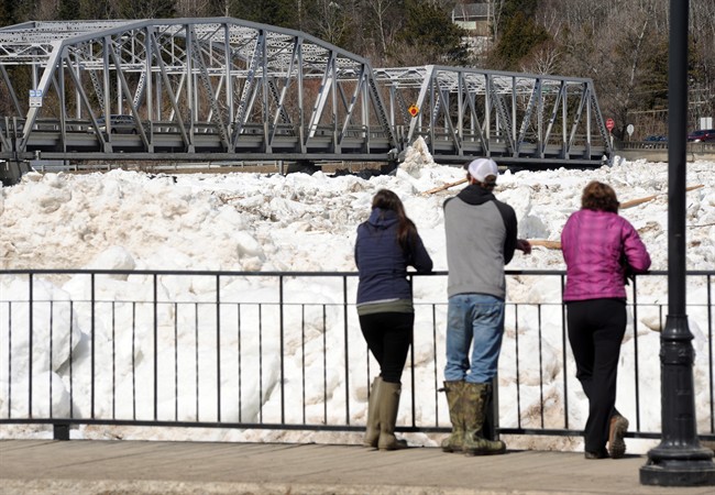 People check out the ice jammed around the bridge crossing the St. John River in the Village of Perth-Andover on Sunday, April 19, 2015.
