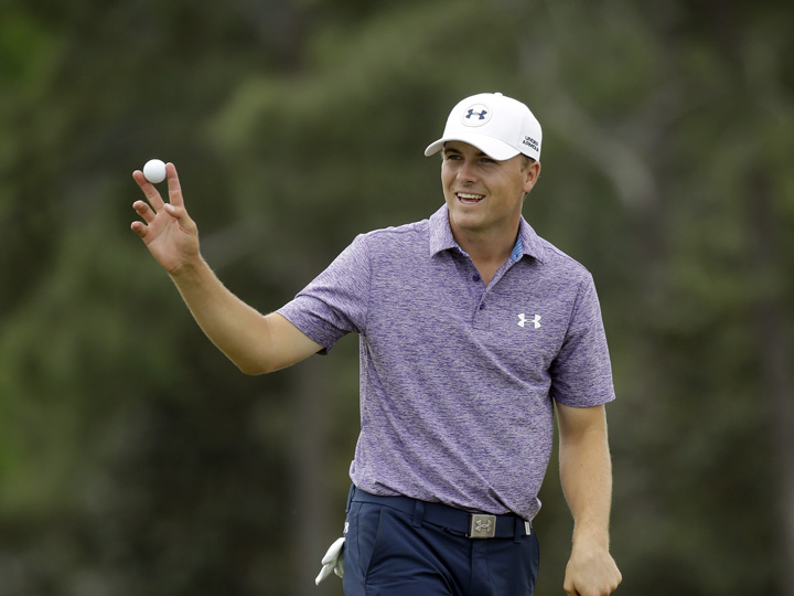Jordan Spieth holds up his ball after putting out on the 18th hole after his second round of the Masters golf tournament Friday, April 10, 2015.