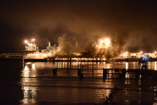 Dark and smelly smoke from a fire at a deep-water port billowed over the town of Squamish, B.C., Thursday night April 16, 2015, forcing municipal officials to ask residents to stay indoors. 