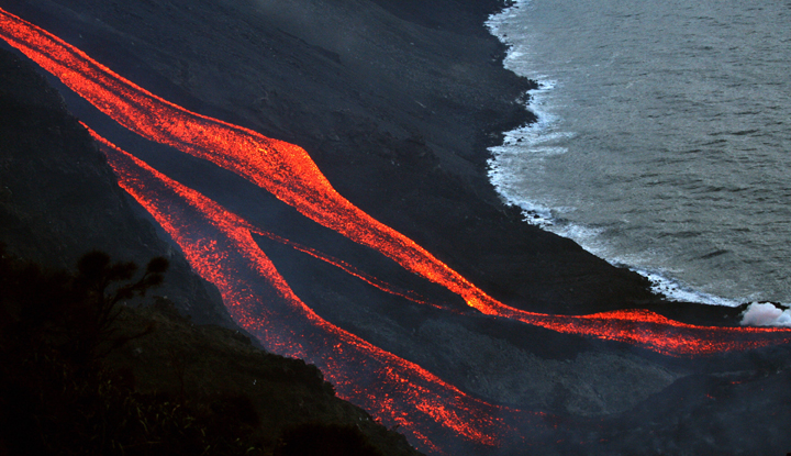 The flanks of the Stromboli volcano north of Sicily spews lava towards the sea.