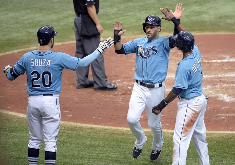 Tampa Bay Rays' Kevin Kiermaier, center, is congratulated by Steven Souza Jr. (20) and Tim Beckham, right, after scoring off a single by Brandon Guyer during the sixth inning of a baseball game against the Toronto Blue Jays in St. Petersburg, Fla., Sunday, April 26, 2015. Both Beckham and Kiermaier scored on the play. 