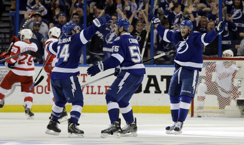 Tampa Bay Lightning defenseman Braydon Coburn (55) celebrates his goal against the Detroit Red Wings with teammates right wing Ryan Callahan (24) and center Steven Stamkos (91) during the third period of Game 7 of a first-round NHL Stanley Cup hockey playoff series Wednesday, April 29, 2015, in Tampa, Fla. The Lightning won the game 2-0. 