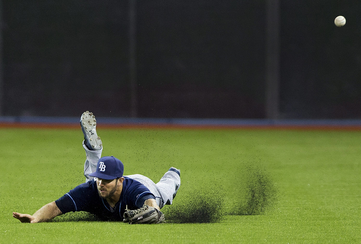 Tampa Bay Rays fielder misses a catch and lands in a spray of rubber pellets