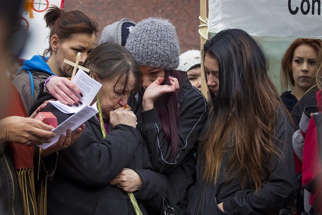 Family members embrace one another as protesters rally outside Edmonton’s City Hall on Thursday, April 2, 2015 in support of Cindy Gladue