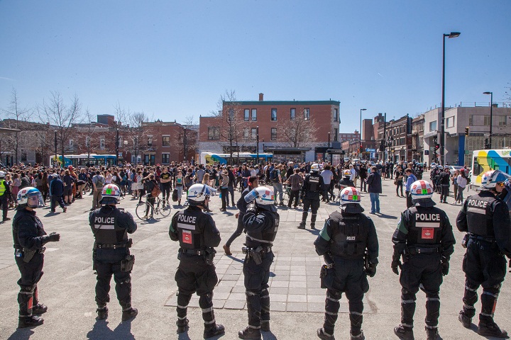 Police officers get ready to watch a student demonstration against austerity, at Mont-Royal metro station in Montreal, on April 13, 2015.