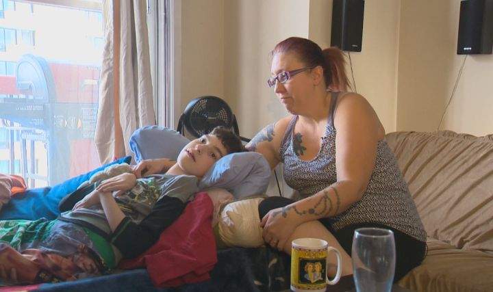 Amanda Nichol sits in her Edmonton home with her son, Avery, days after her specially equipped van was stolen. 