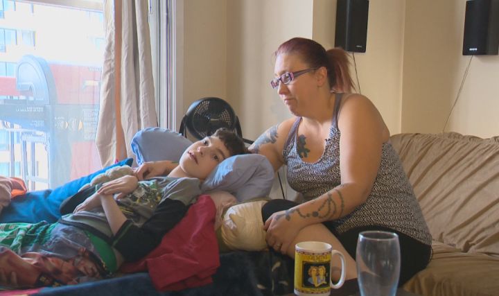 Amanda Nichol sits in her Edmonton home with her son, Avery, days after her specially equipped van was stolen. 