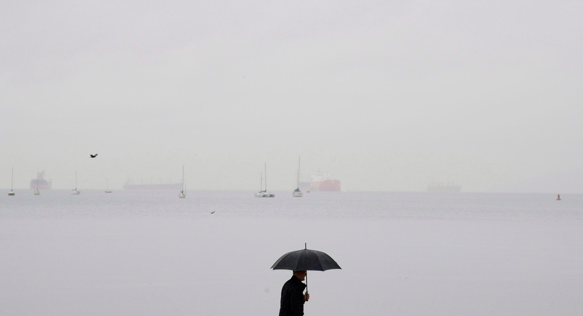 Man under umbrella in Vancouver