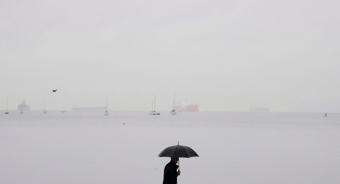 Man under umbrella in Vancouver
