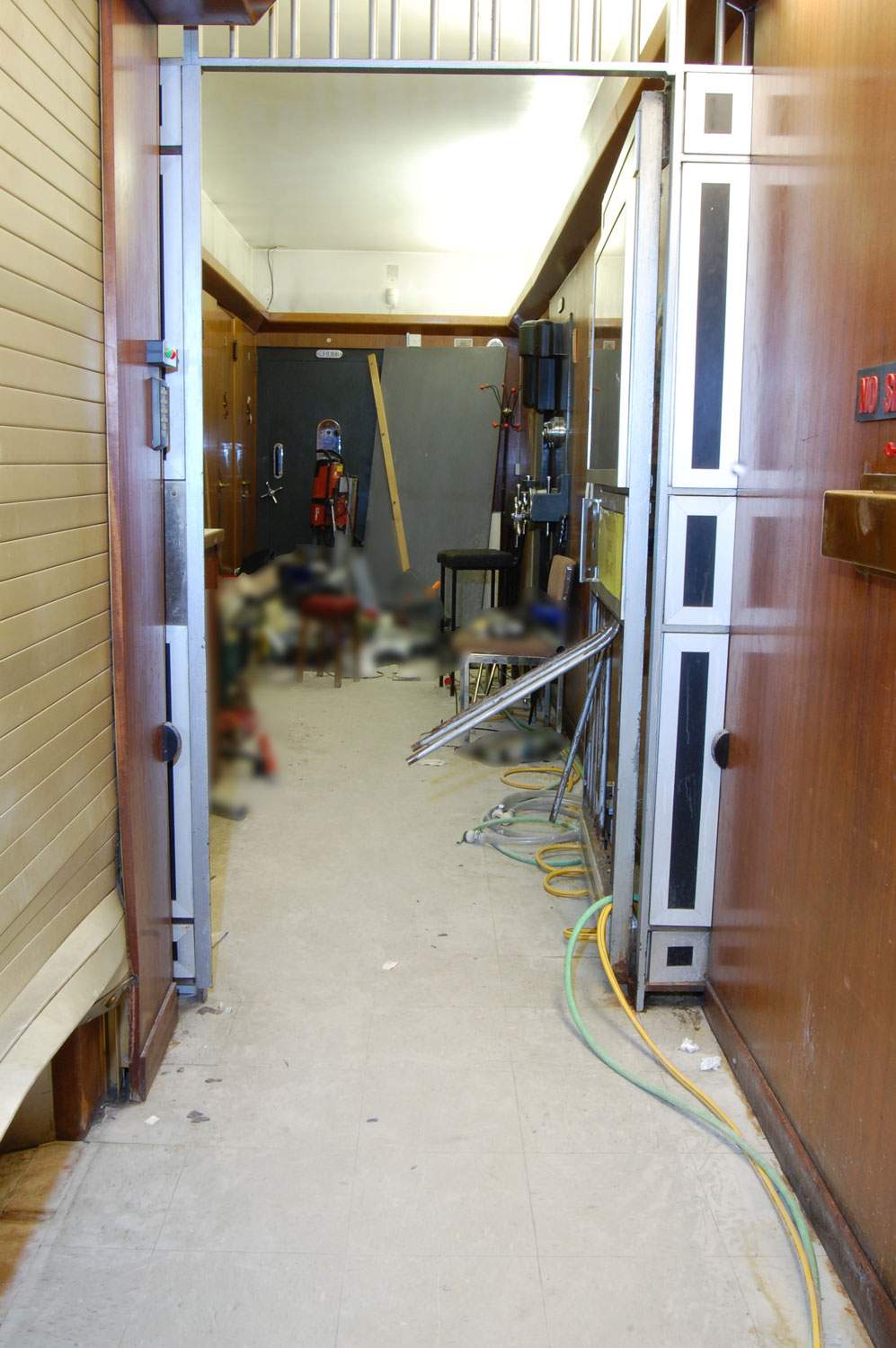 The vault corridor shows debris and power tools left on the floor.