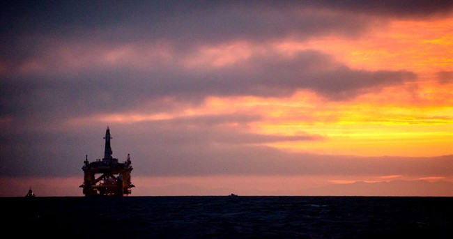 An oil drilling rig arrives aboard a transport ship at sunrise, following a journey across the Pacific, Friday, April 17, 2015, in Port Angeles, Wash.