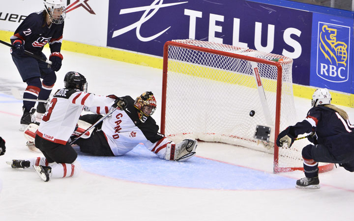 Brianna Decker of the U.S, right, scores her team's sixth goal past Canada's goalkeeper Genevieve Lacasse  during the 2015 IIHF Ice Hockey Women's World Championship final between U.S. and Canada at Malmo Isstadion in Malmo, Sweden, on Sat. April 4, 2015.