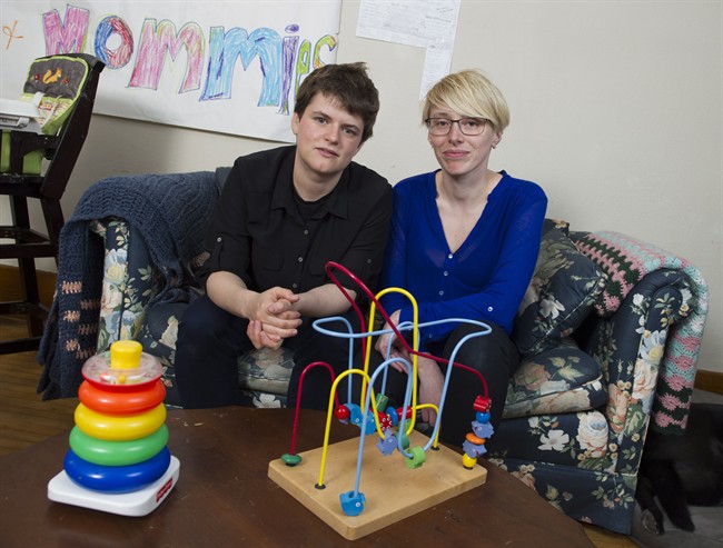 Kate Taylor (left) and partner Agata Durkalec are photographed in their Winnipeg home on Thursday, April 2, 2015. The couple recently encountered homophobic discrimination while searching for daycare for their infant daughter. 