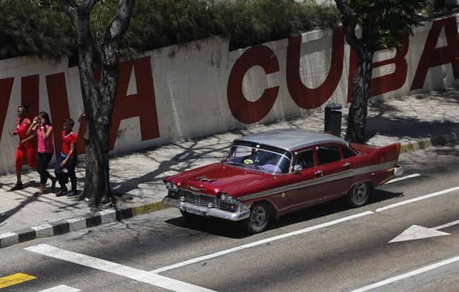 A taxi driver steers his classic American car through Havana, Cuba, Tuesday, April 14, 2015.