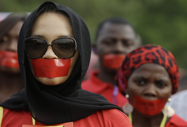 People march during a silent protest calling on the government to rescue the kidnapped girls of the government secondary school in Chibok, who were abducted a year ago, in Abuja, Nigeria, Monday, April 13, 2015. 