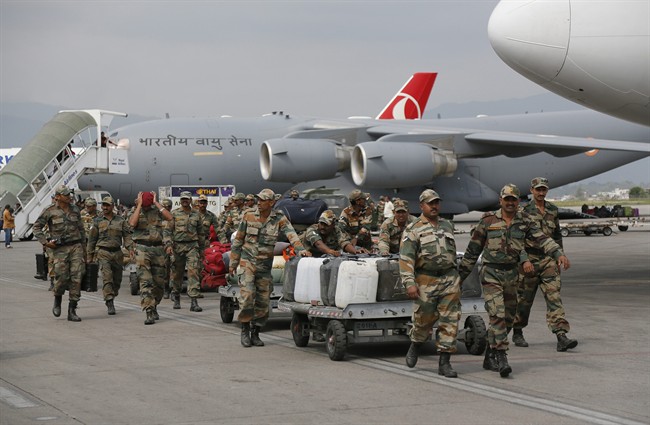 Indian soldiers arrive with supplies at the Tribhuwan International Airport a day after a massive earthquake in Kathmandu, Nepal, Sunday, April 26, 2015.