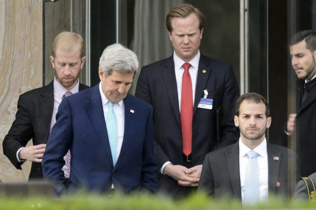 U.S. Secretary of State John Kerry, front left, walks during a break outside the Beau Rivage Palace Hotel as the Iran nuclear talks continue, in Lausanne, Switzerland, Wednesday, April 1, 2015.