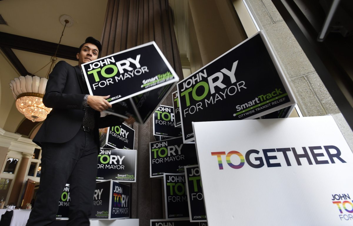 Jesse Lutersz, a campaign volunteer sets up sign trees as preparations are underway for John Tory's election night gathering at the Liberty Grand on Oct 27 2014.
