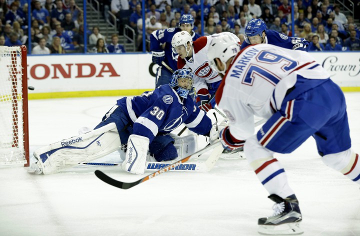 Montreal Canadiens defenseman Andrei Markov, right, of Russia, scores a goal against Tampa Bay Lightning goalie Ben Bishop, left, during first period of Game 4 NHL second round playoff hockey action, Thursday, May 7, 2015, in Tampa, Fla.