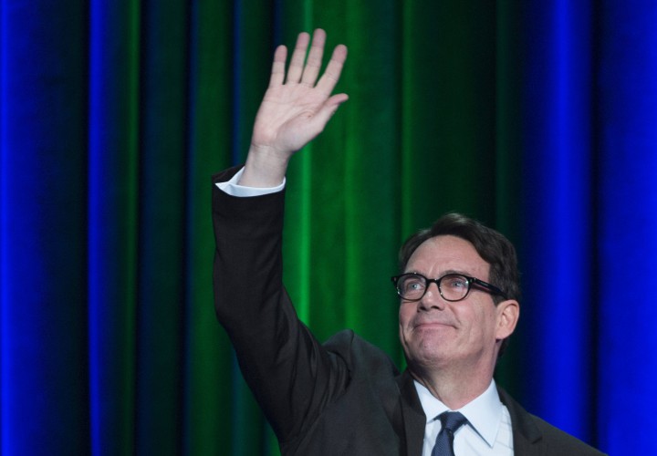 In this file photo, Pierre Karl Peladeau waves to supporters during the final Parti Quebecois leadership debate in Montreal, Thursday, May 7, 2015.