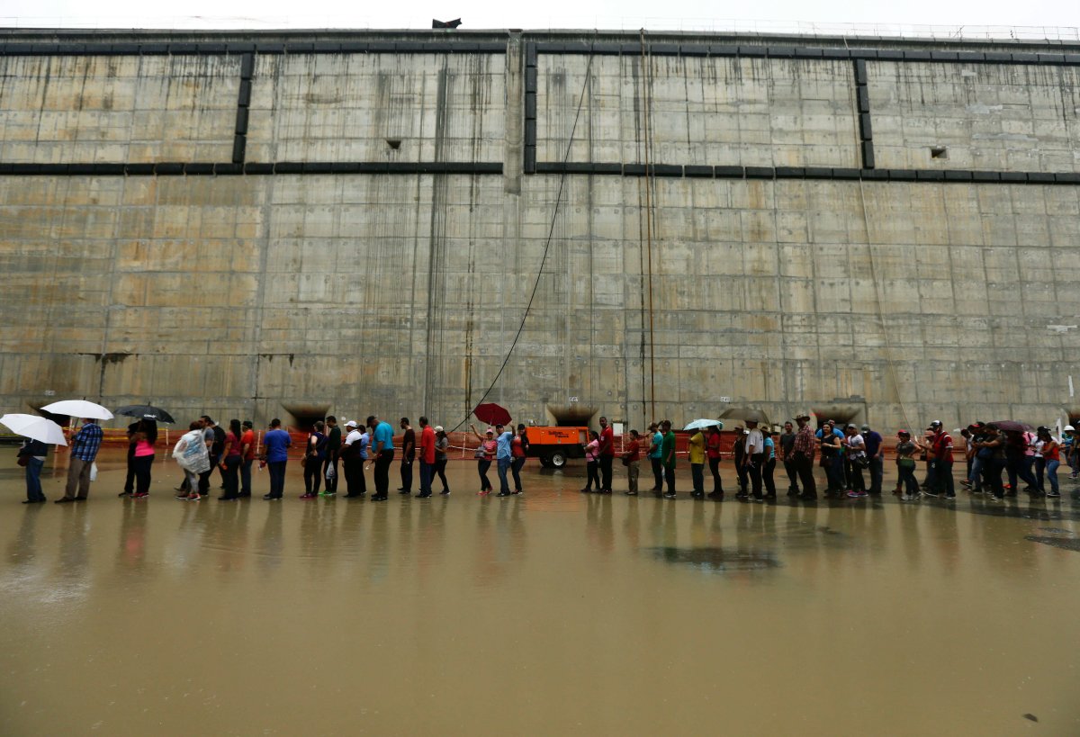 People walk inside the expanded Panama canal's new set of locks before they are flooded in Cocoli, near Panama City, Sunday, May 17, 2015. 