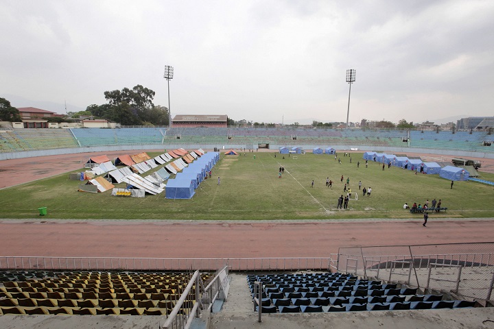 In this Saturday, May 16, 2015 photo, makeshift tents for earthquake survivors are set up at Dasharath Stadium in Kathmandu, Nepal. Two recent earthquakes killed more than 8,300 people and have had a devastating impact on all aspects of life in Nepal, including sports. A revered national volleyball coach is among the thousands of dead, trapped in his rented house when devastating earthquakes rocked Nepal. The national football stadium venue was damaged, before becoming a makeshift refuge for displaced survivors of the quakes. The cricket teams preparations for an elite international tournament next year are disarray. (AP Photo/Niranjan Shrestha).
