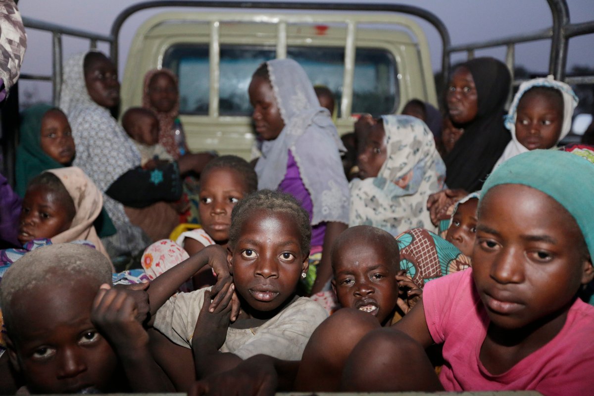 In this Saturday May 2, 2015 file photo, women and children rescued by Nigeria soldiers from Islamist extremists at Sambisa forest arrive at a camp for the displaced people in Yola, Nigeria.