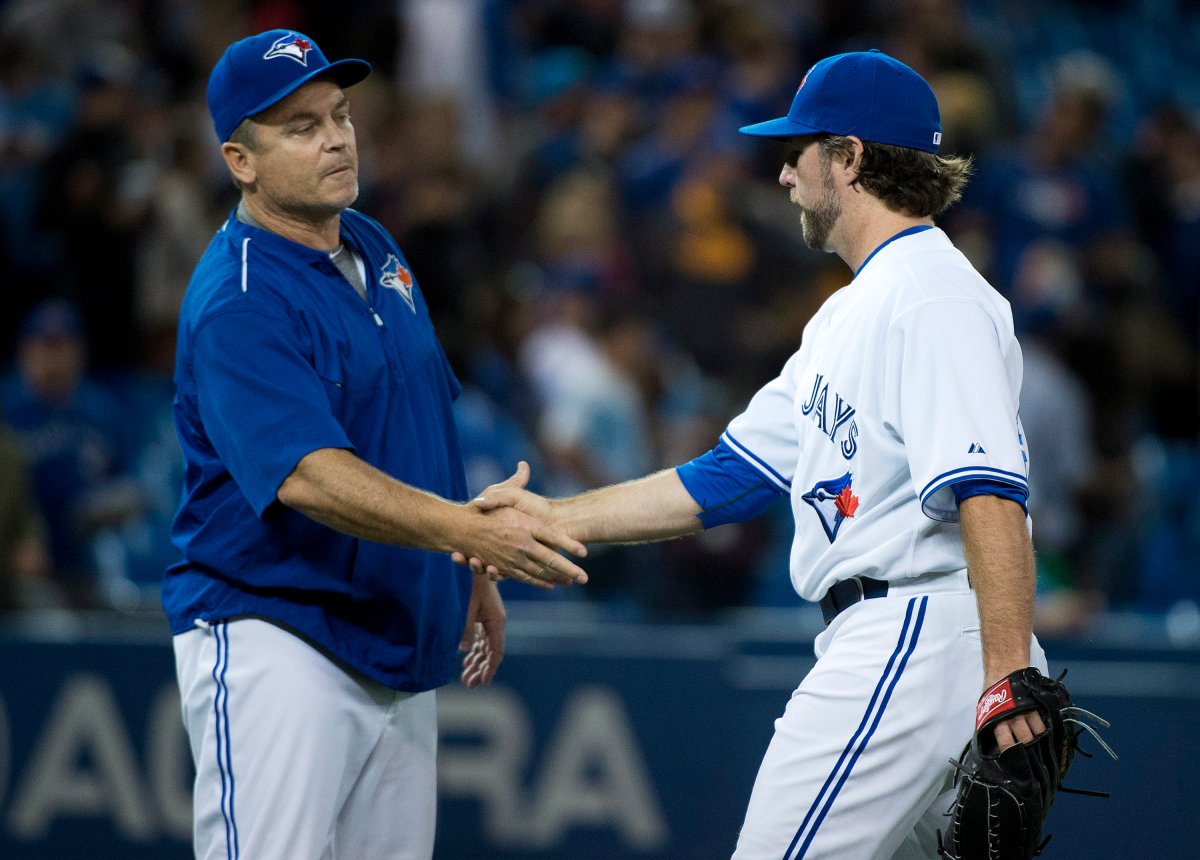 Toronto Blue Jays starting pitcher R.A. Dickey, right, celebrates his win and compete game with Blue Jays manager John Gibbons after defeating the Los Angeles Angels in AL baseball action in Toronto on Thursday, May 21, 2015. 