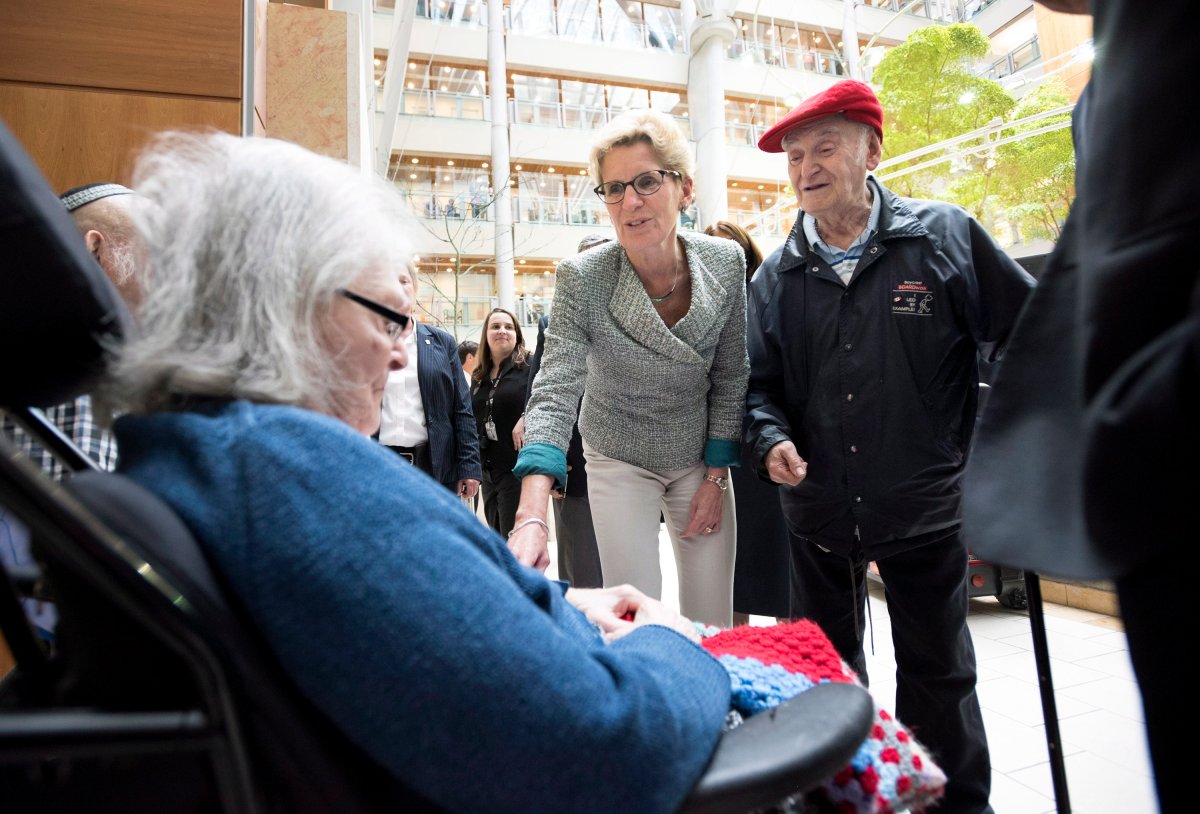 Ontario Premier Kathleen Wynne, centre, sings with resident Blema Mazin, left, and her husband Monty at the Canadian Centre for Aging and Brain Health Innovation at Baycrest Health Sciences Centre in Toronto on Friday, May 22, 2015.