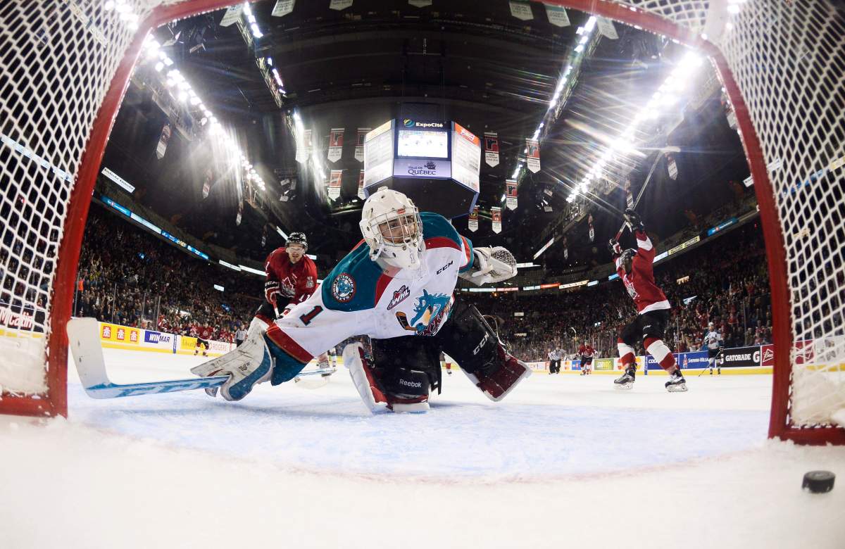 Kelowna Rockets goalie Jackson Whistle watches the puck enter the net against the Quebec Remparts during third period action Friday, May 22, 2015 at the Memorial Cup tournament in Quebec City. Anthony Duclair, right, and Marc-Olivier Roy , left, celebrate. 