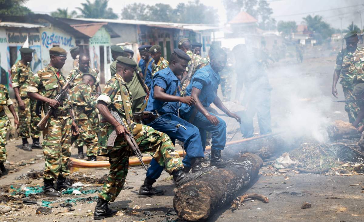Police and army clear barricades set by opposition demonstrators in the Cibitoke district of the capital Bujumbura, in Burundi Monday, May 25, 2015.