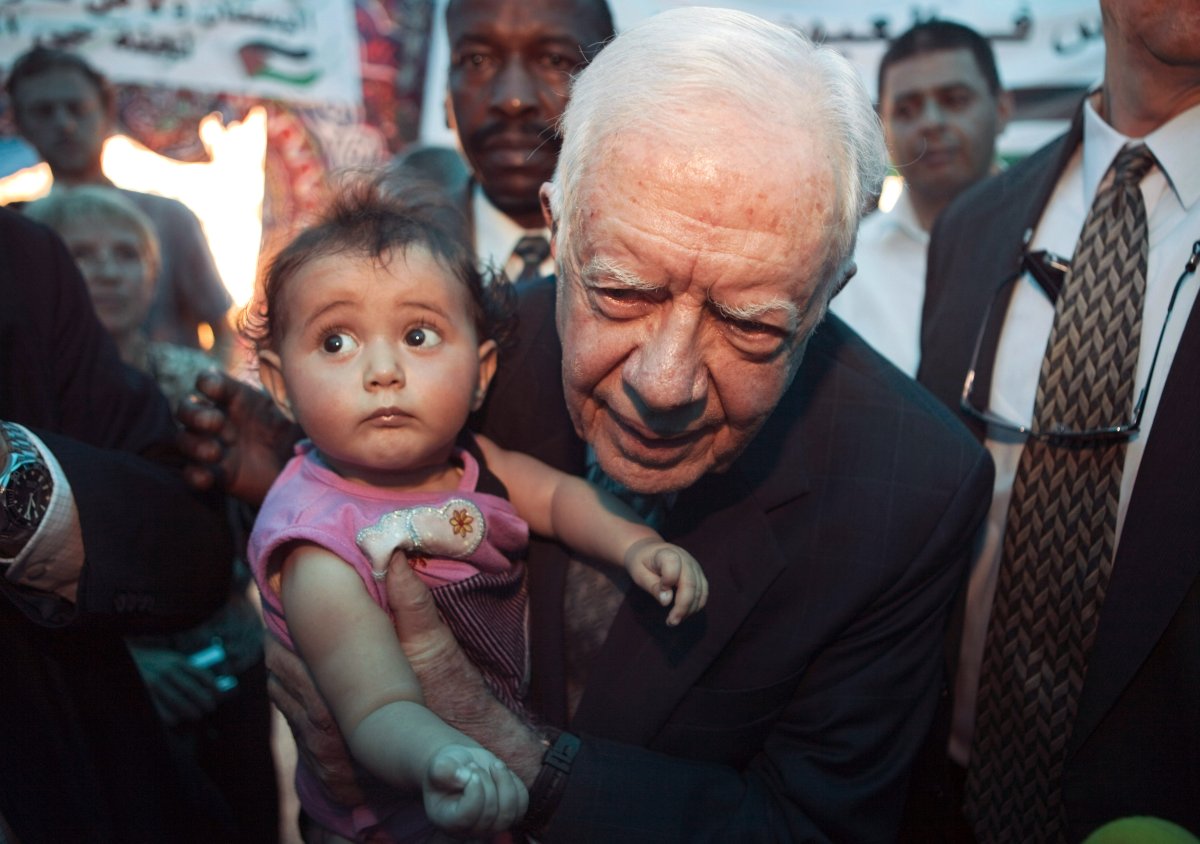 Former U.S. President Jimmy Carter holds a Palestinian baby girl during a visit to the Arab East Jerusalem neighborhood of Silwan on October 21, 2010 in East Jerusalem.