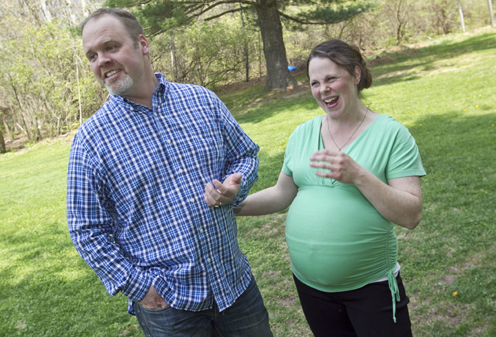 Kateri and Jay Schwandt stand outside their Rockford, Mich. home Wednesday, May 6, 2015. The couple, have 12 boys, and are expecting a baby on May 9, the day before Mother’s Day, and they’re sticking to their tradition of not finding out in advance whether they’re having a boy or girl.