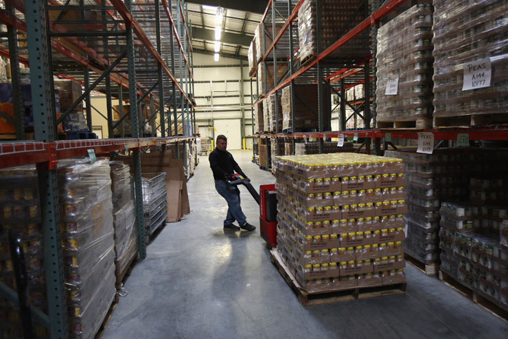 A worker moves a pallet load of peanut butter in a food bank warehouse in this file image. Toronto's Daily Bread Food Bank distributed over 130,000 pounds of peanut butter last year. "It’s a healthy, filling and cost-effective way to get the protein you need," a spokesperson explains.